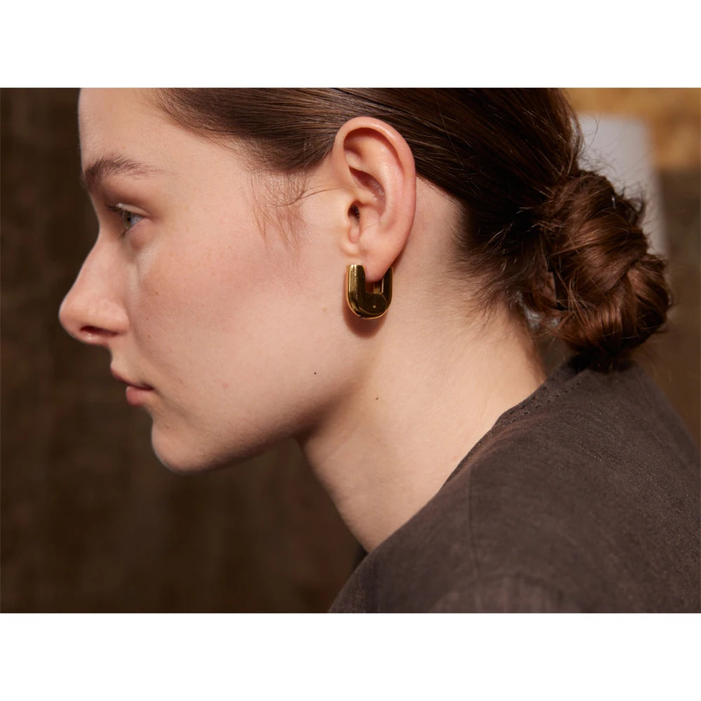 U-Shaped Gold Hoop Earrings on a clean product background